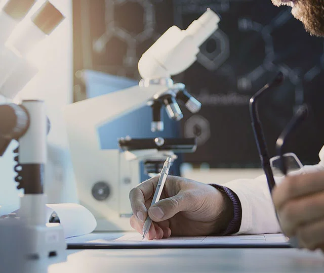 A lab professional working on a branded lab report in the Moldlab office—representing professionalism, partnership, and trusted mold and asbestos lab services for inspectors.